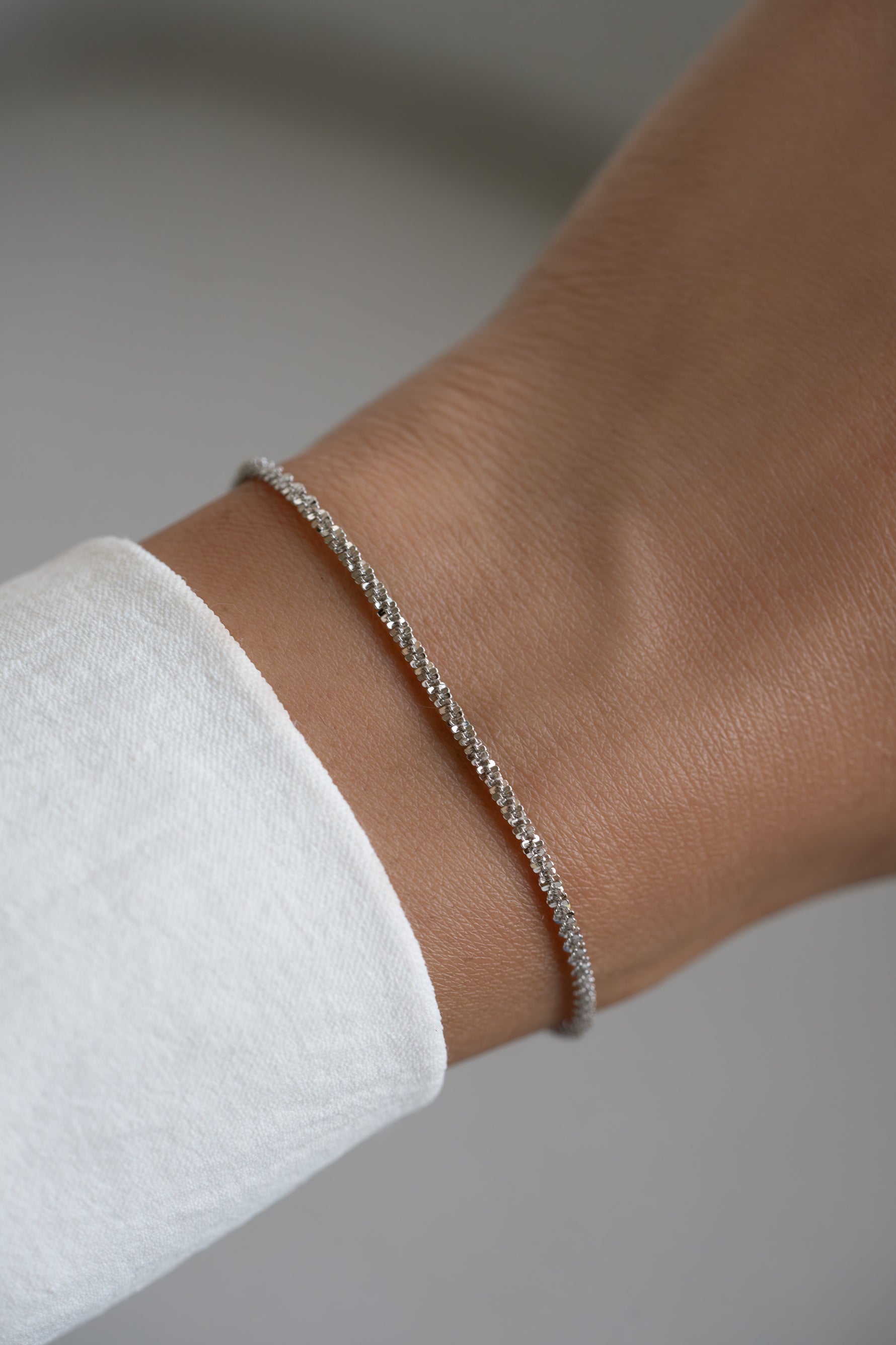 Sterling silver diamond cut rope chain bracelet by Sami Jewels featuring intricate twisted design and polished finish.