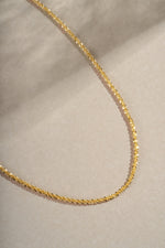 Close-up of a gold diamond-cut rope chain necklace from Sami Jewels showing intricate chain links and polished finish.