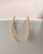 Close-up of Sami Jewels gold studded ear climber earring with diamond accents on a plain background.