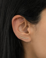 Gold studded ear climber earrings by Sami Jewels featuring diamond accents on a stylish model.