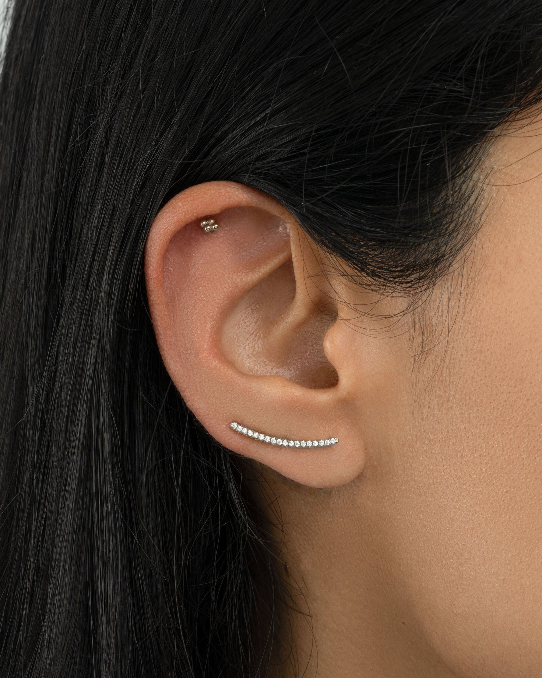 Sterling silver studded ear climber earrings by Sami Jewels featuring diamond accents on a model.