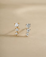 Diamond CZ ear climber earrings by Sami Jewels in gold and sterling silver, showcasing elegant, curved design on the ear.