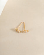 Close-up of Sami Jewels CZ ear climber earrings with sparkling diamonds in a gold finish, showcasing elegant ear jewelry.