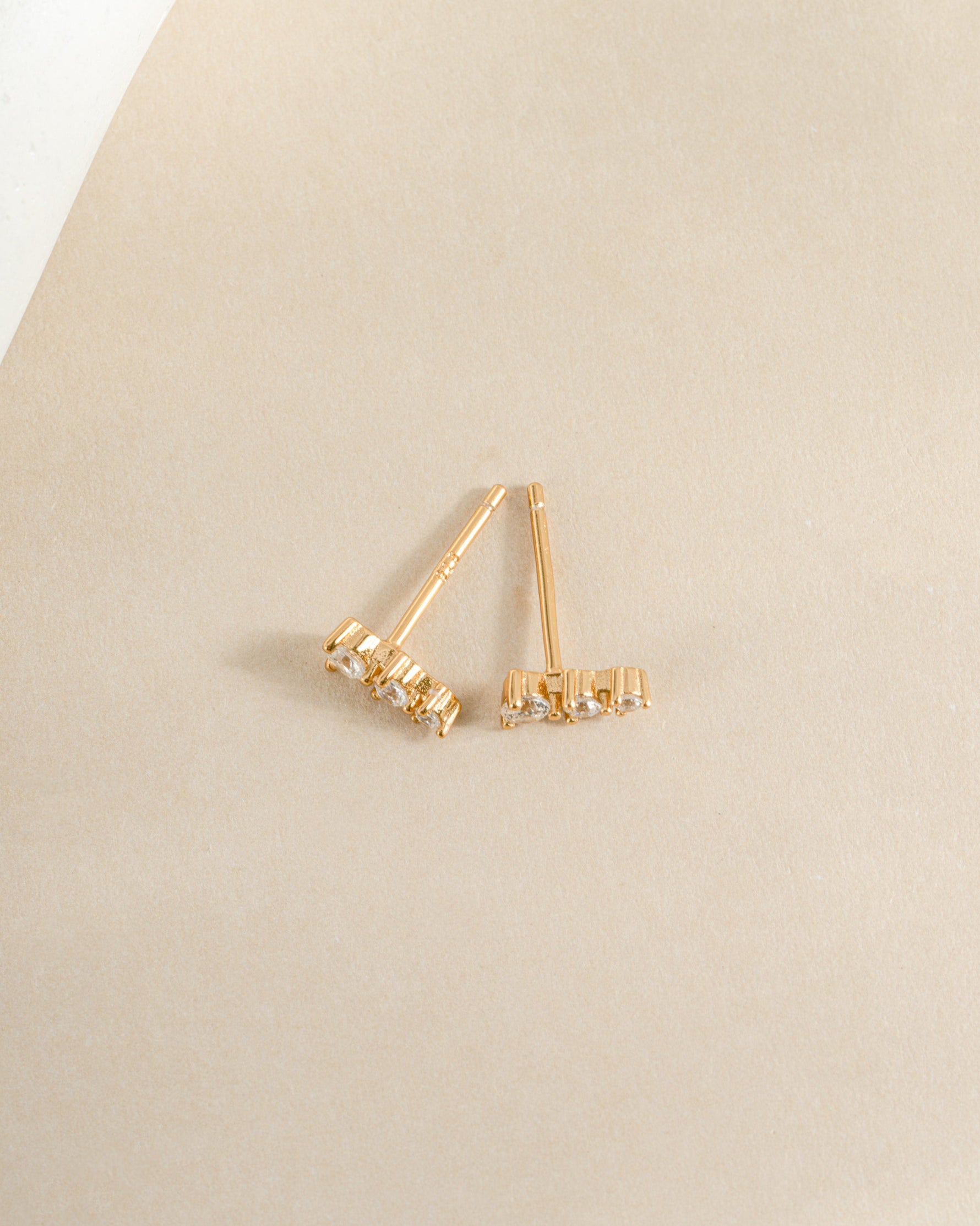 Close-up of Sami Jewels CZ ear climber earrings with sparkling diamonds in a gold finish, showcasing elegant ear jewelry.