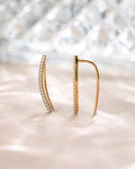 Gold studded ear climber earrings by Sami Jewels, featuring diamond accents on a neutral background.