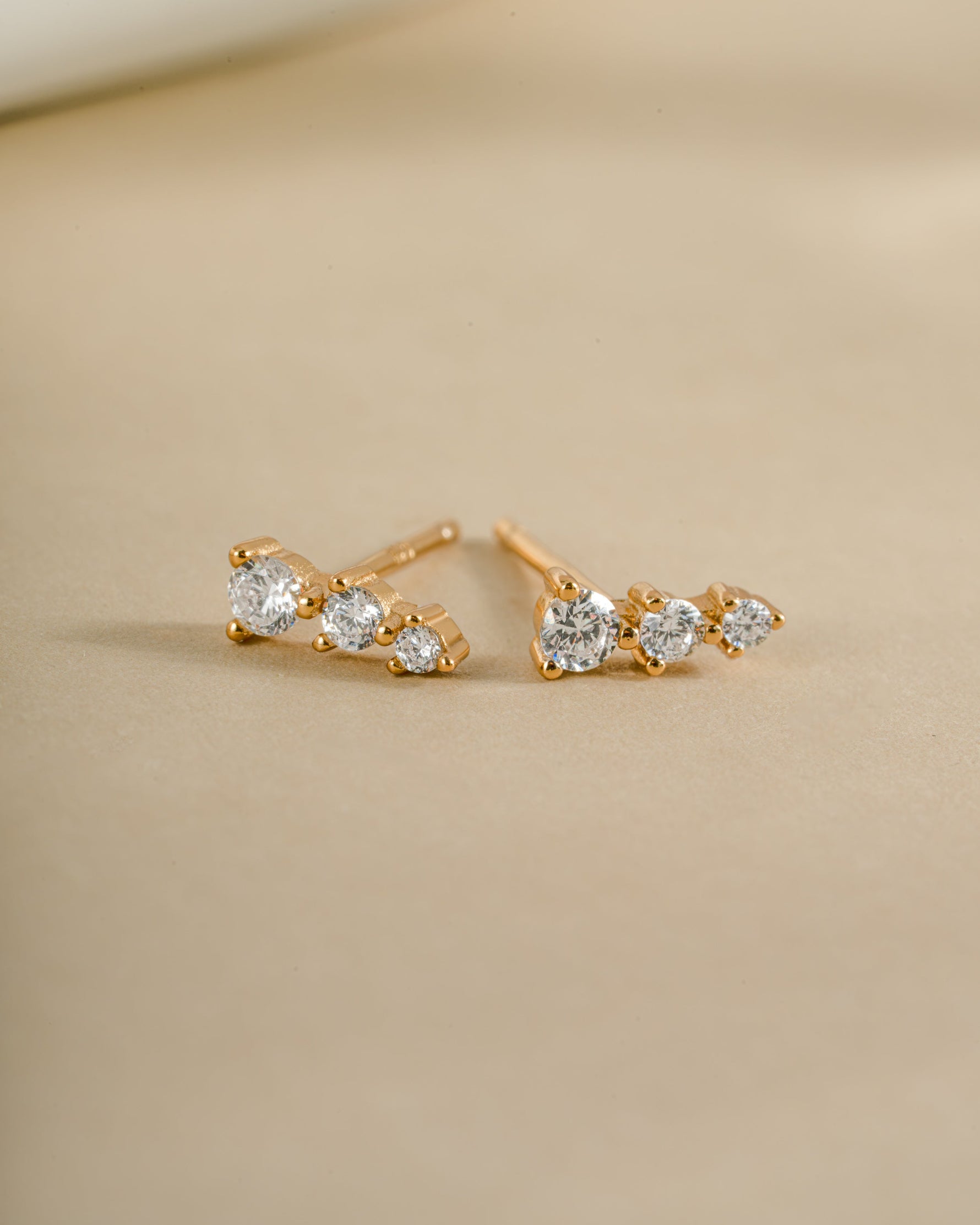 Gold CZ ear climber earrings by Sami Jewels, side view showing sparkling diamond accents and elegant curved design.