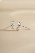 Sami Jewels CZ ear climber earrings in sterling silver with diamond accents, shown from an angled view on the ear.