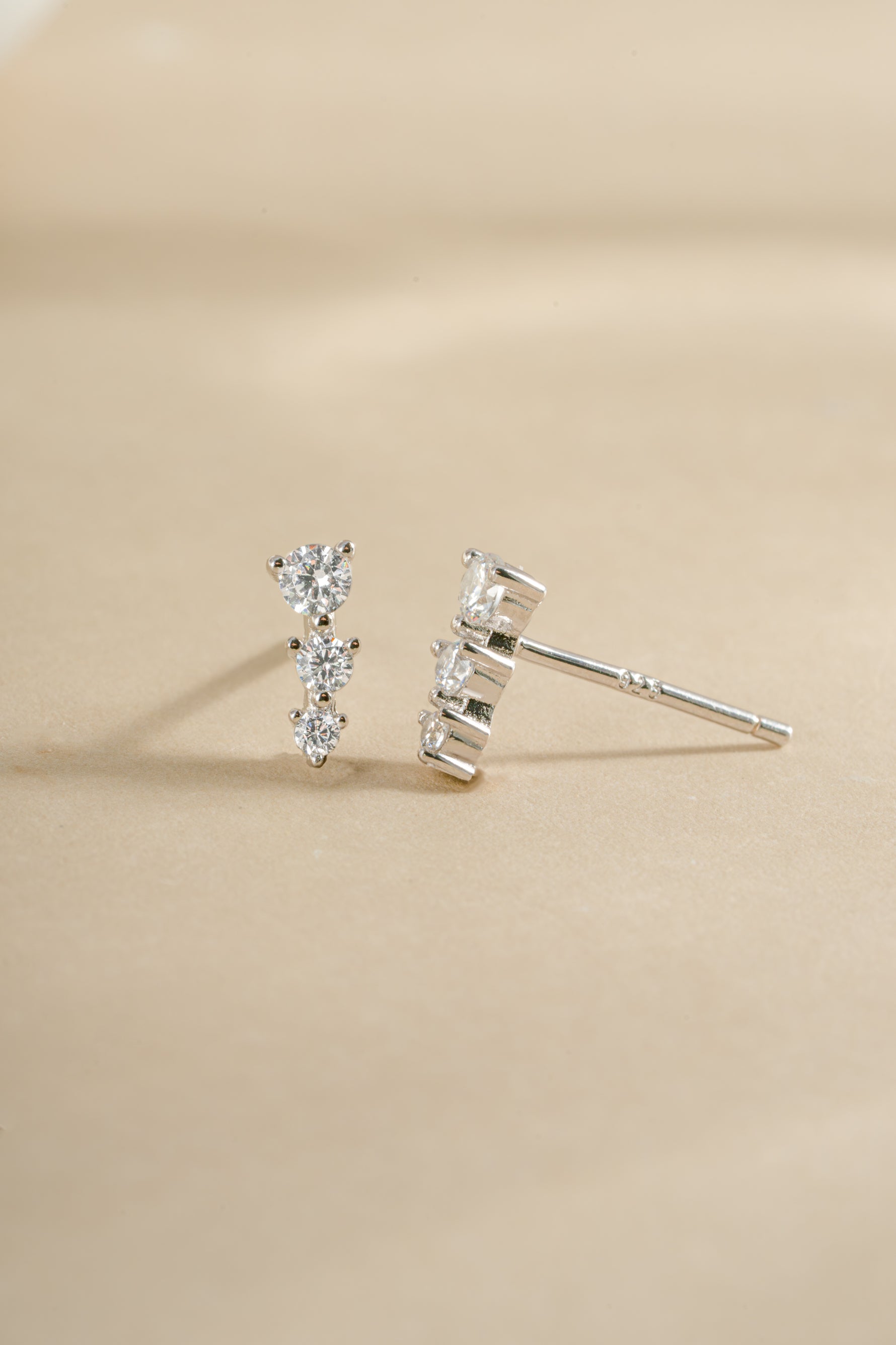 Sami Jewels CZ ear climber earrings in sterling silver with diamond accents, shown from an angled view on the ear.