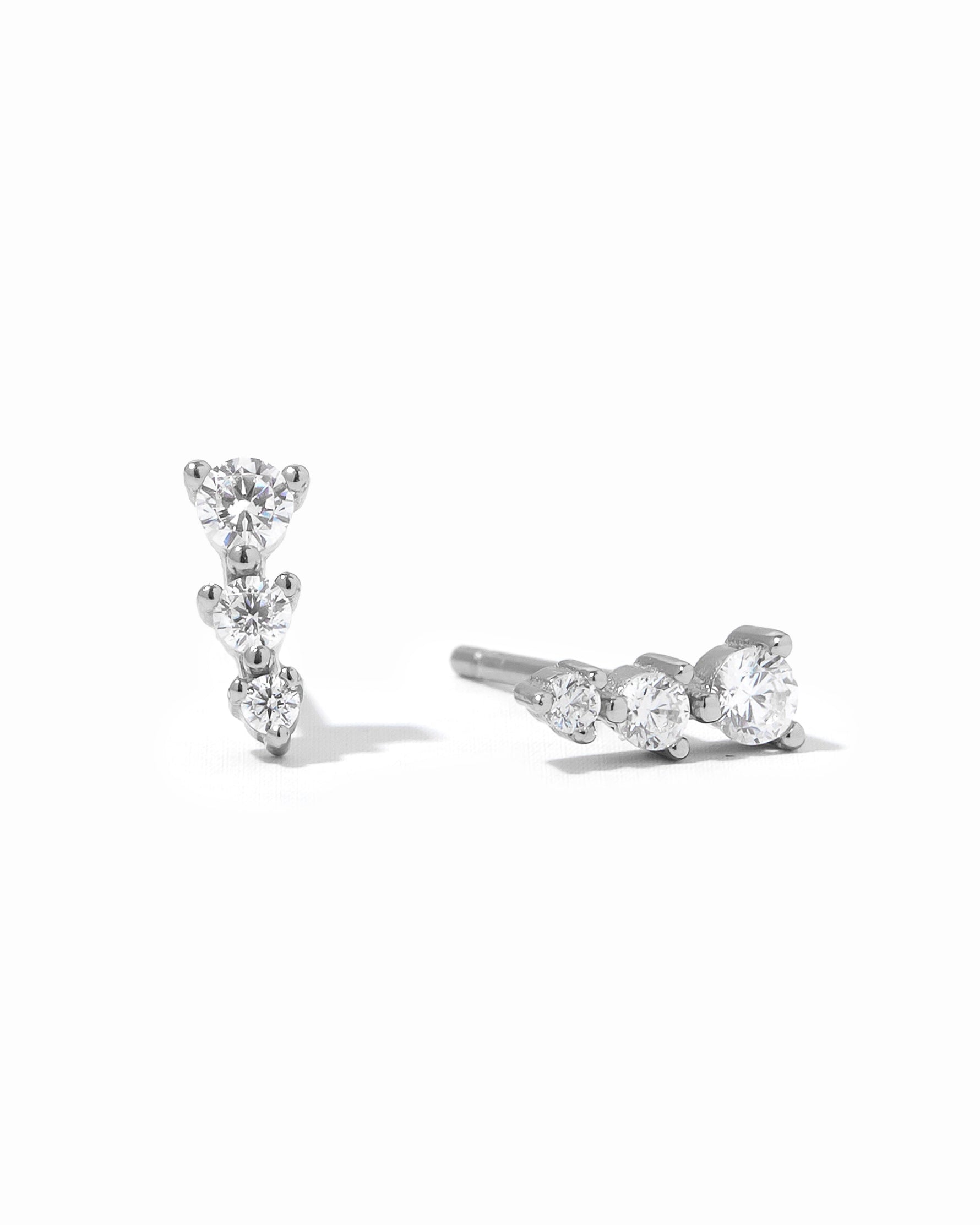 Sterling silver CZ ear climber earrings by Sami Jewels with sparkling diamond-like accents on a white background.
