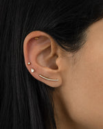 Gold studded ear climber earrings with diamond accents by Sami Jewels worn on a model's ear.