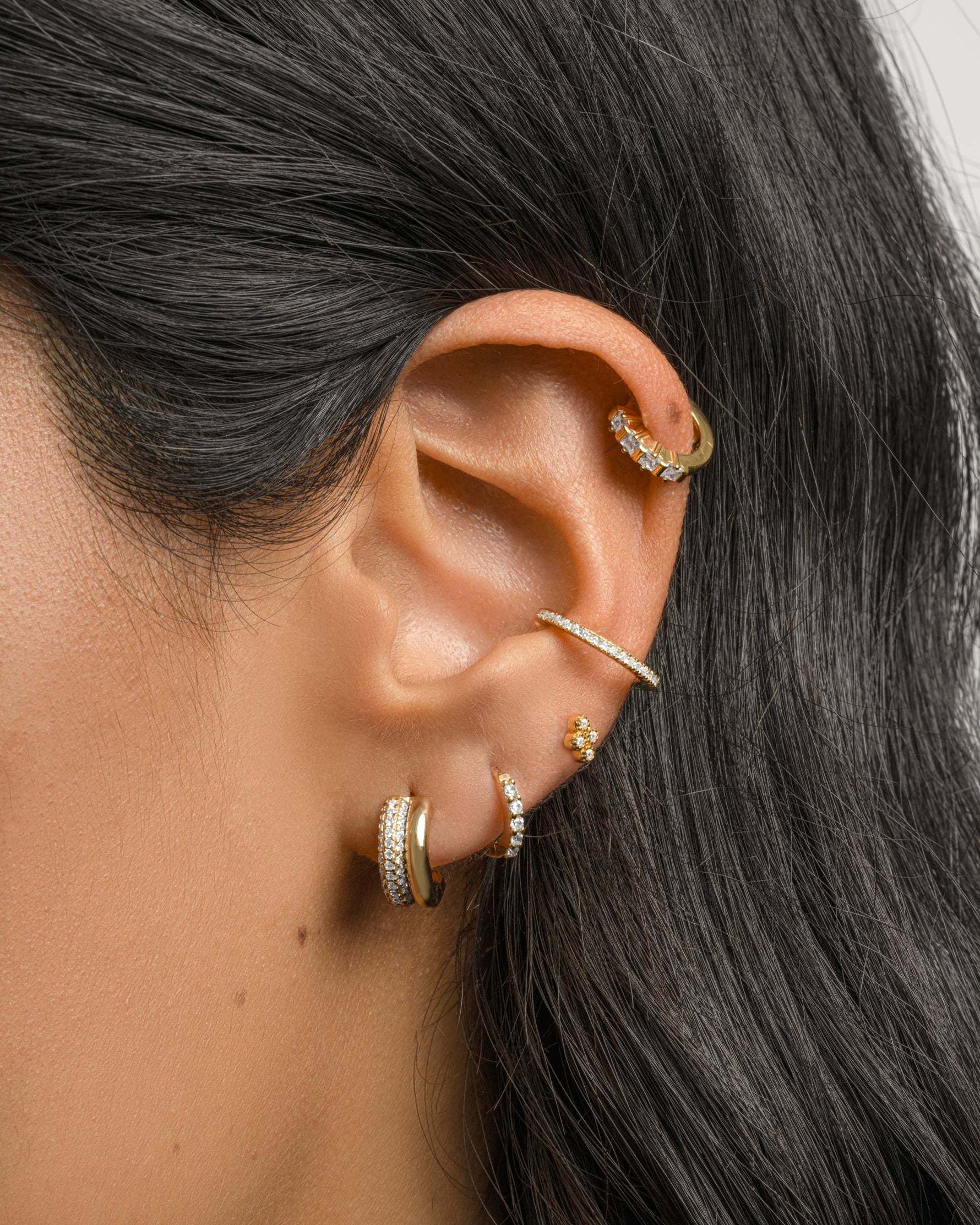 Gold diamond ear cuff earrings by Samijewels-527 worn on a model, showcasing elegant and sparkling jewelry accessory.