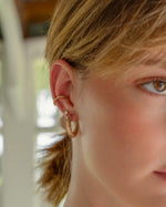 Gold diamond ear cuff earrings by Samijewels-527 worn on a model, showcasing elegant jewelry design and sparkling diamonds.