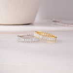 flat lay of a gold ring and silver ring, perfect when worn together or styled solo. 