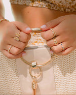 Sami Jewels Rebecca Eternity Ring with diamond accents on a gold band, showcasing a continuous circle of sparkling stones.