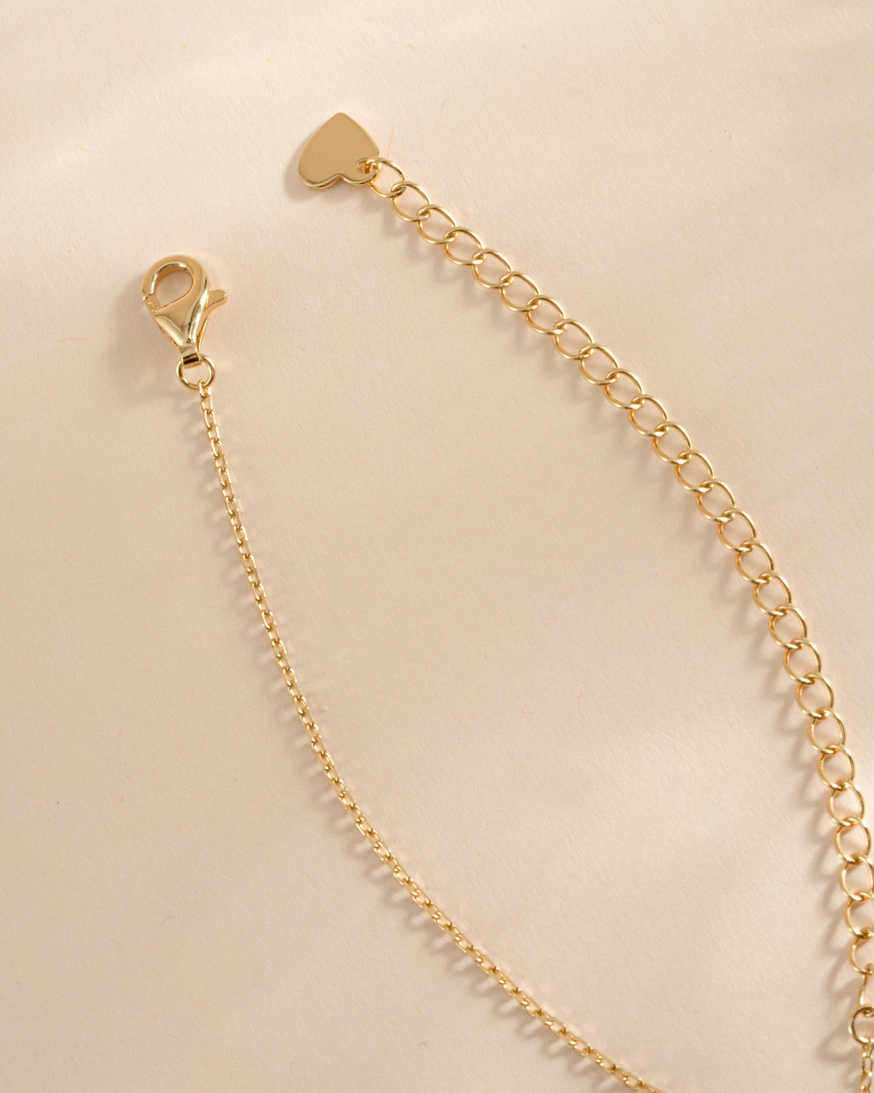 Gold diamond flower necklace with a charming pendant and lobster clasp closure, by SJ Faire.