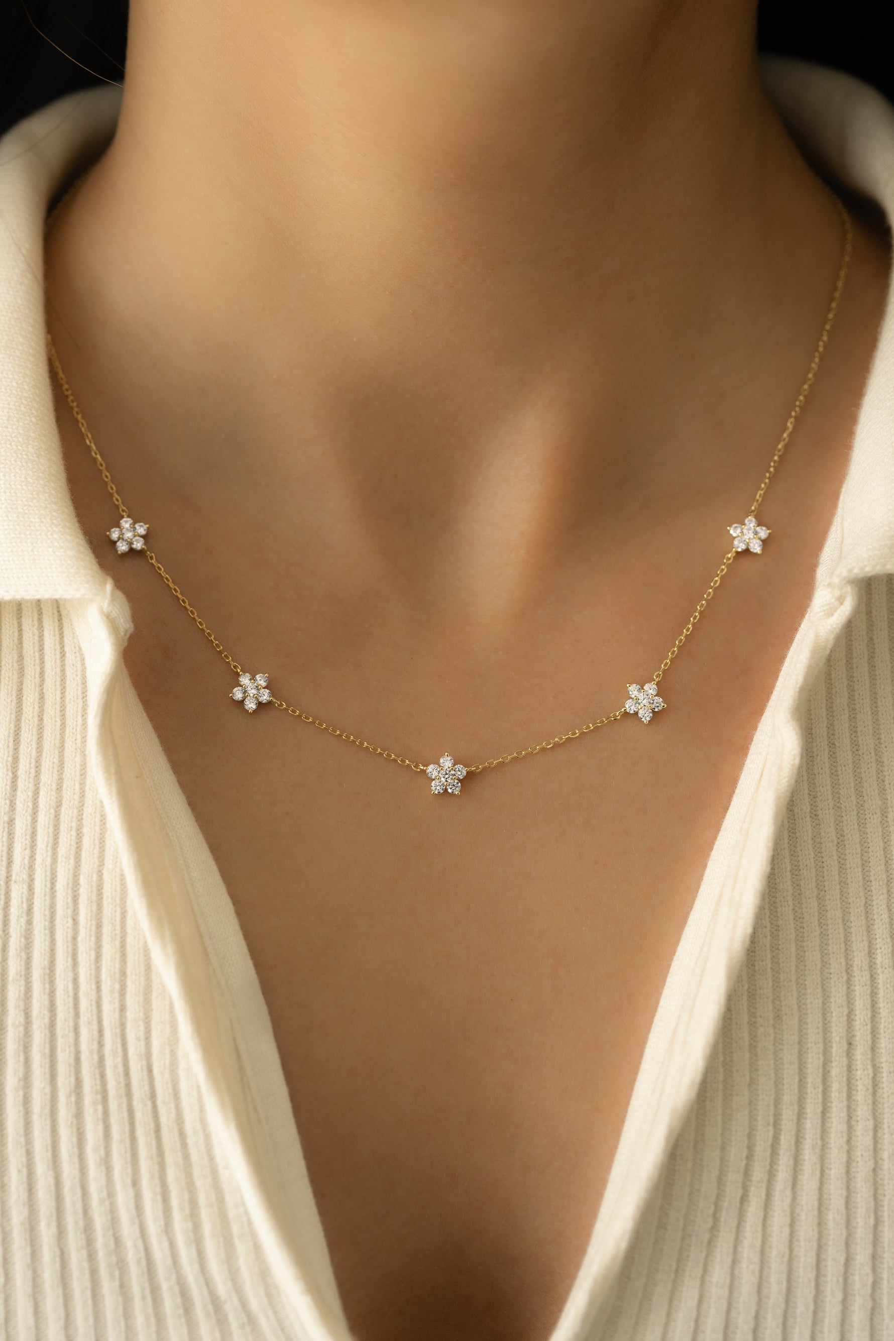 Gold diamond flower necklace by SJ Faire featuring a delicate floral charm on a sleek chain.