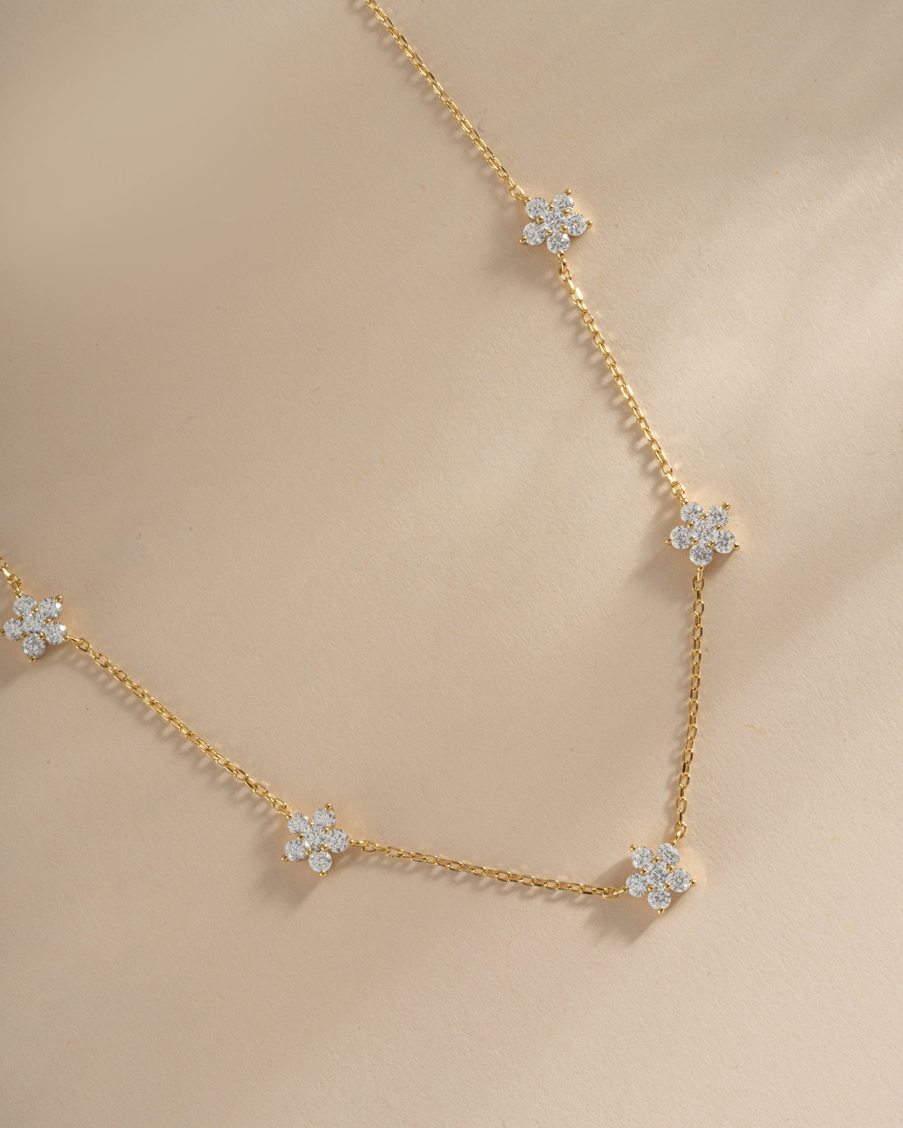 Close-up of SJ Faire Diamond Flower Necklace showcasing intricate gold flower design with sparkling diamonds.