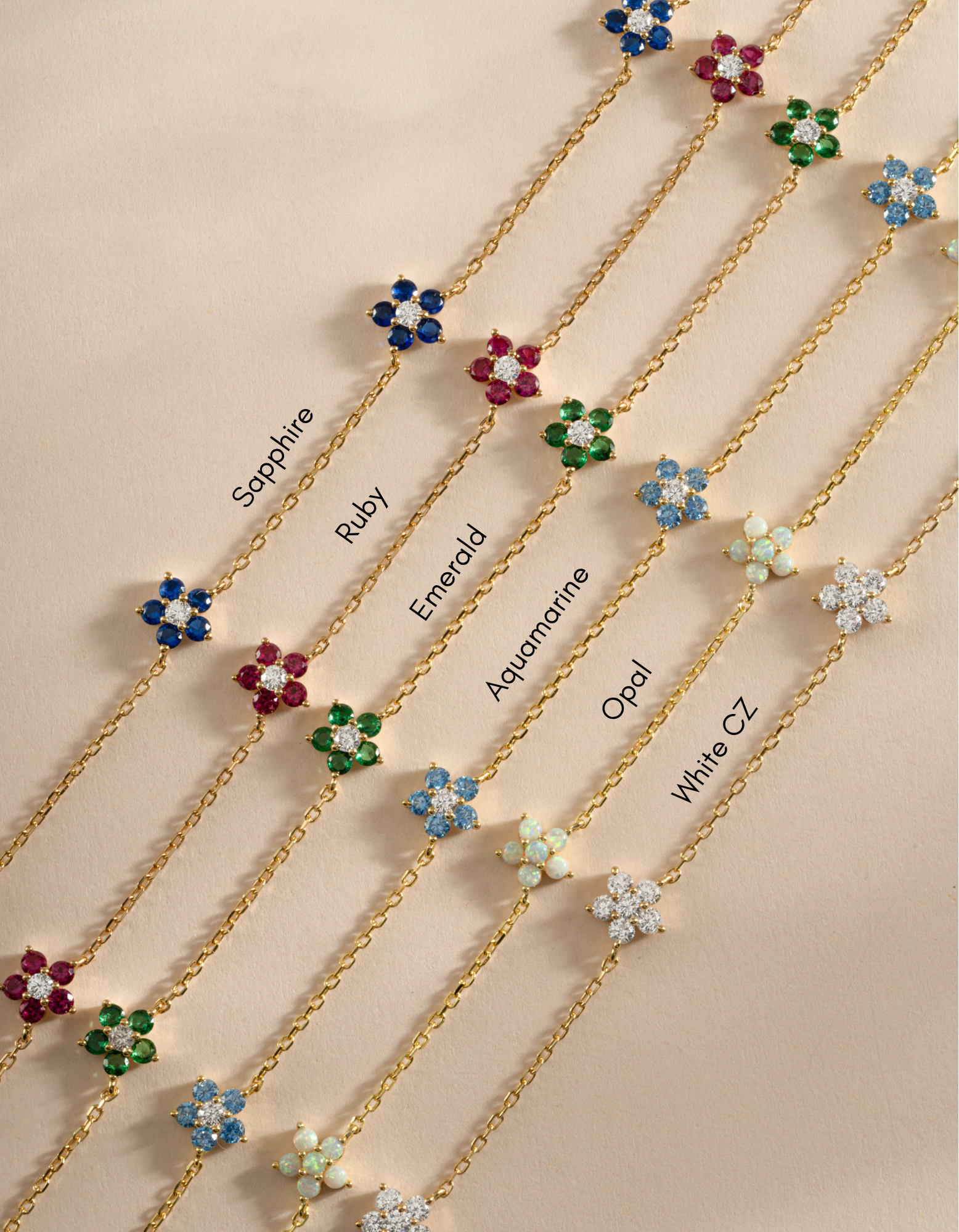 Gold Sapphire Flower Necklace by Sami Jewels featuring a diamond-shaped flower pendant with colorful gemstones.