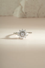 Sterling silver flower ring with diamond accents from Sami Jewels, showcasing intricate floral design and sparkling gemstones.