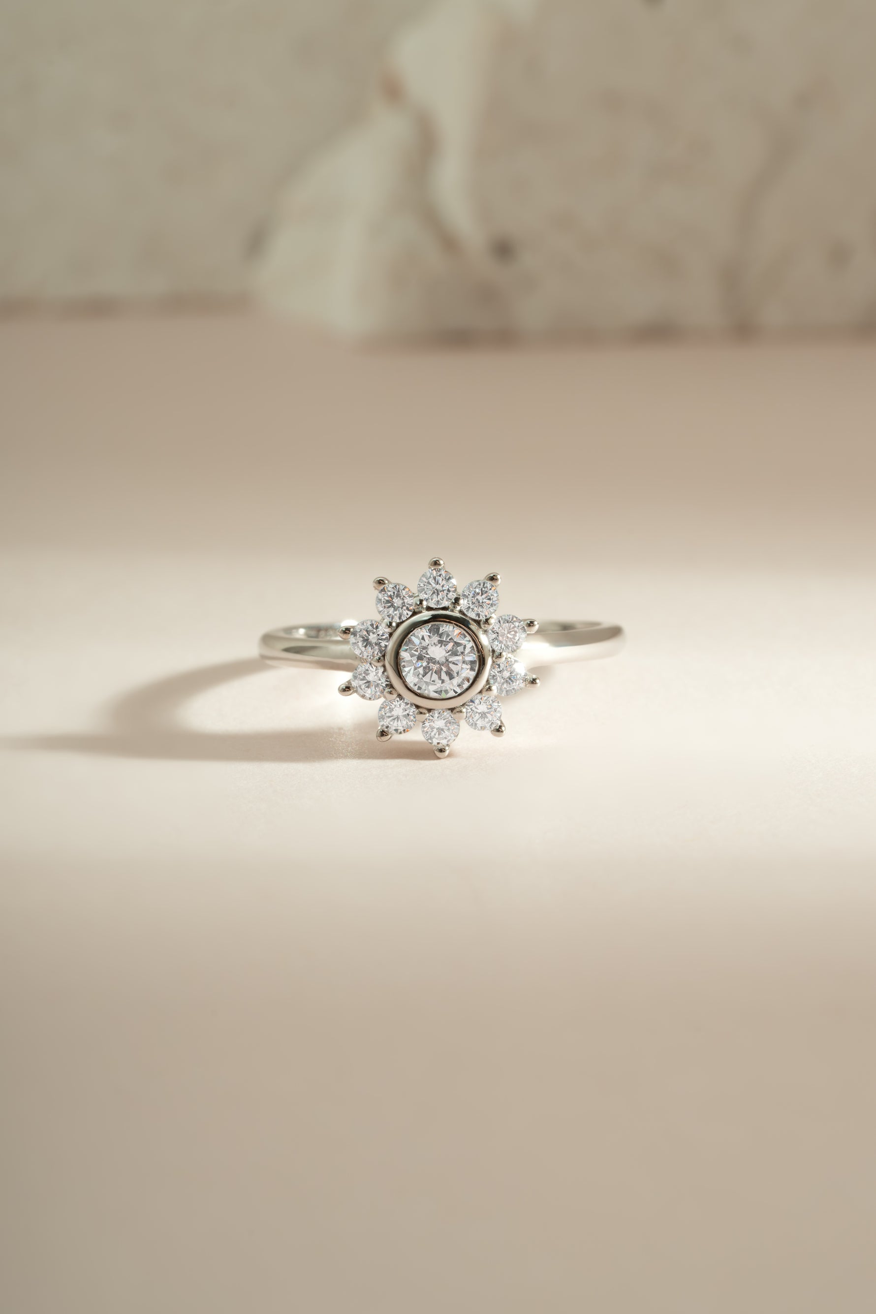 Sterling silver flower ring with diamond accents from Sami Jewels, showcasing intricate floral design and sparkling gemstones.