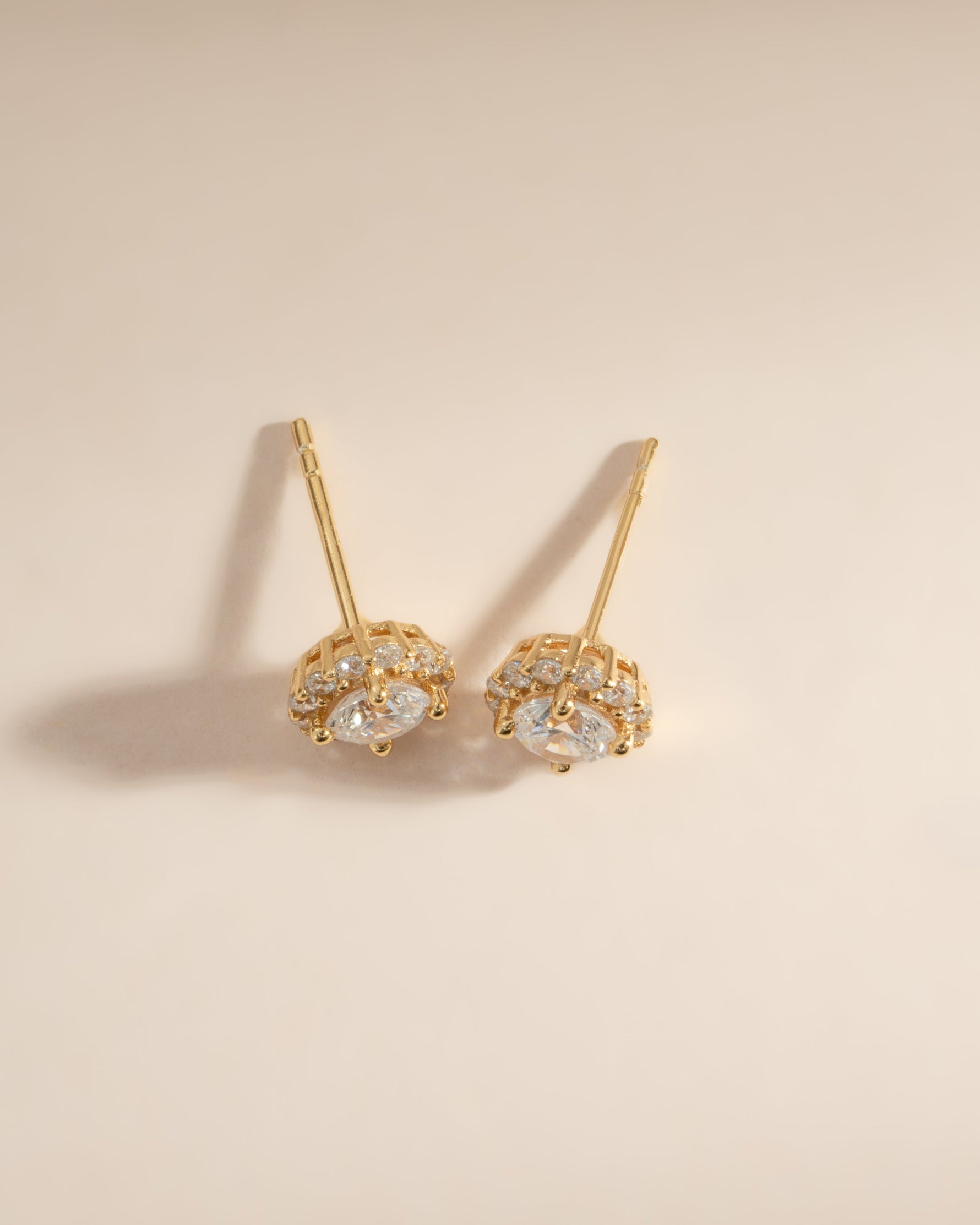 Gold diamond halo stud earrings by Sami Jewels, featuring sparkling diamond accents in a classic stud design.