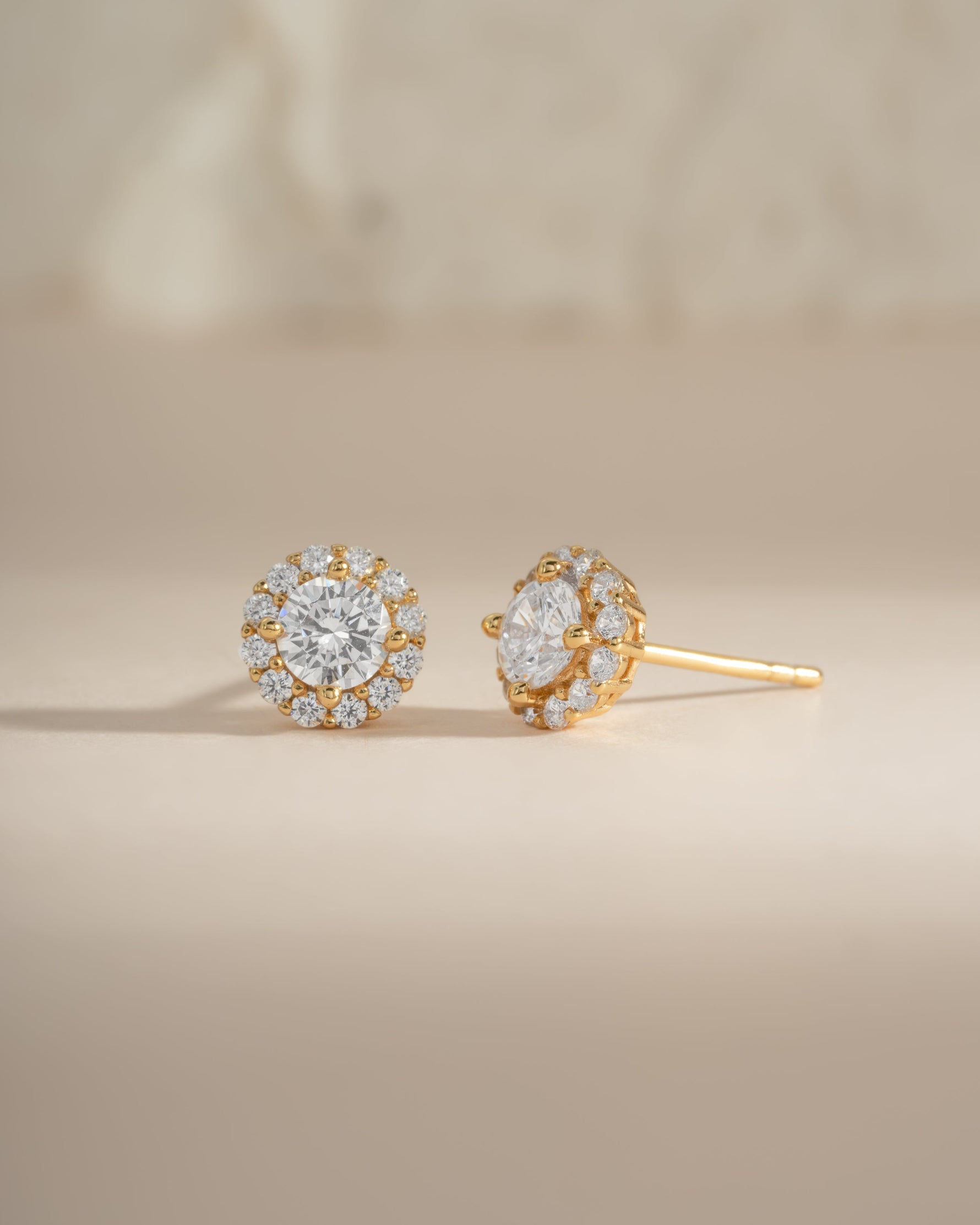 Gold diamond halo stud earrings by Sami Jewels featuring sparkling round diamonds and a classic, elegant design.