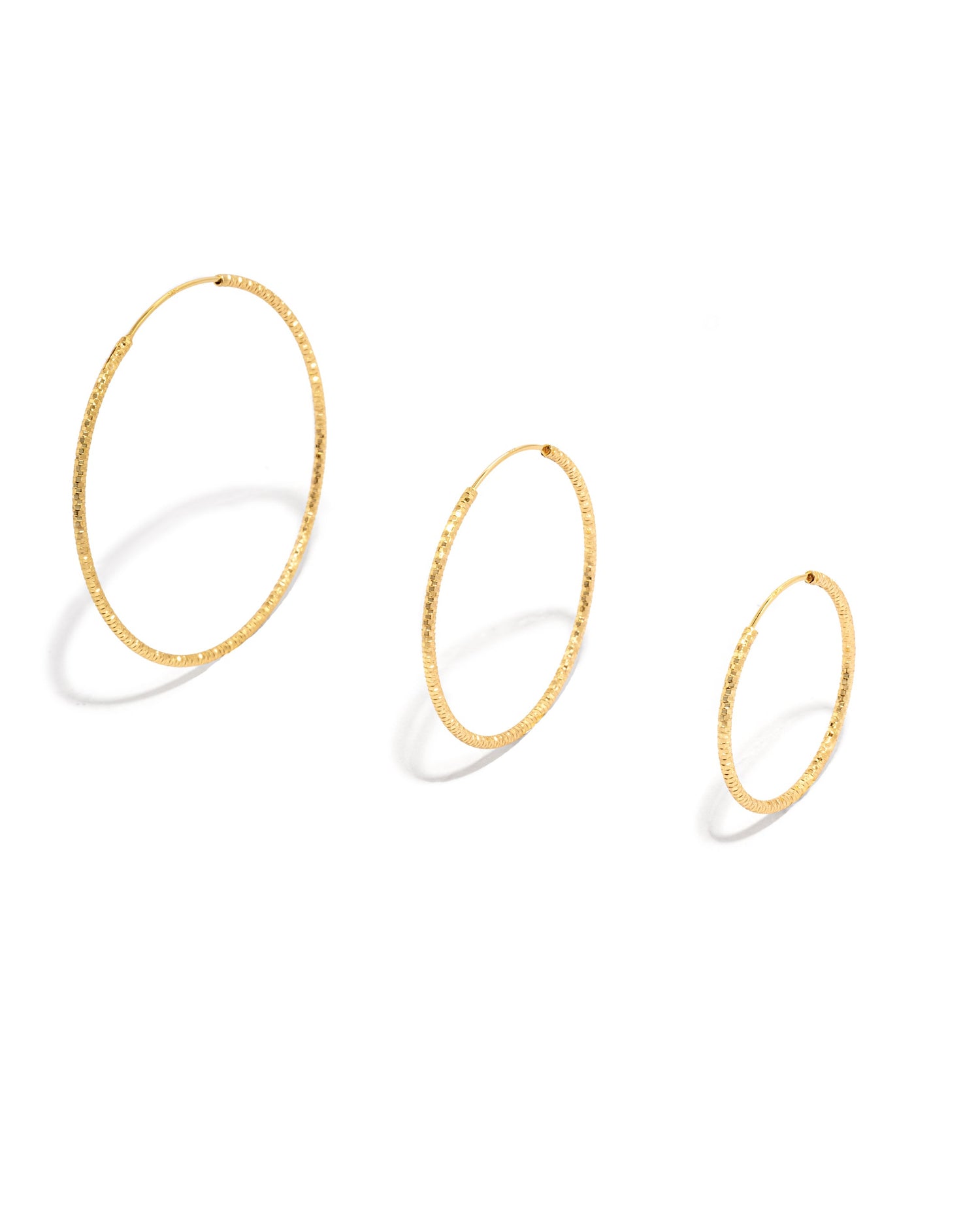 gold hoop earrings on a white background