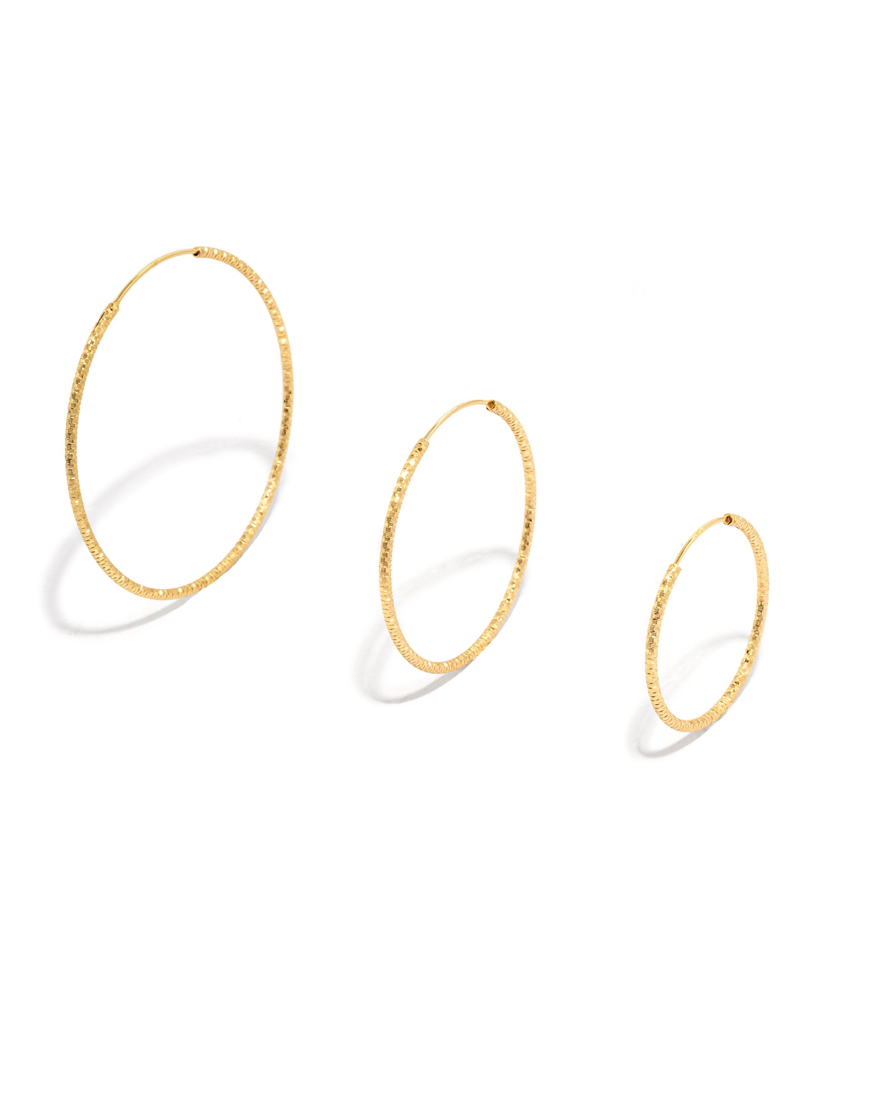 gold hoop earrings on a white background
