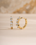 Sami Jewels 9mm gold diamond huggie hoop earrings shown from a side view, close-up of stylish jewelry design.