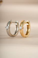 Sami Jewels Bella Huggie Hoop Earrings with diamond accents in sterling silver and gold, close-up of stylish jewelry.