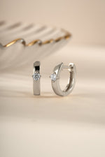 Sami Jewels Bella Huggie Hoop Earrings featuring sparkling diamond accents in sterling silver.