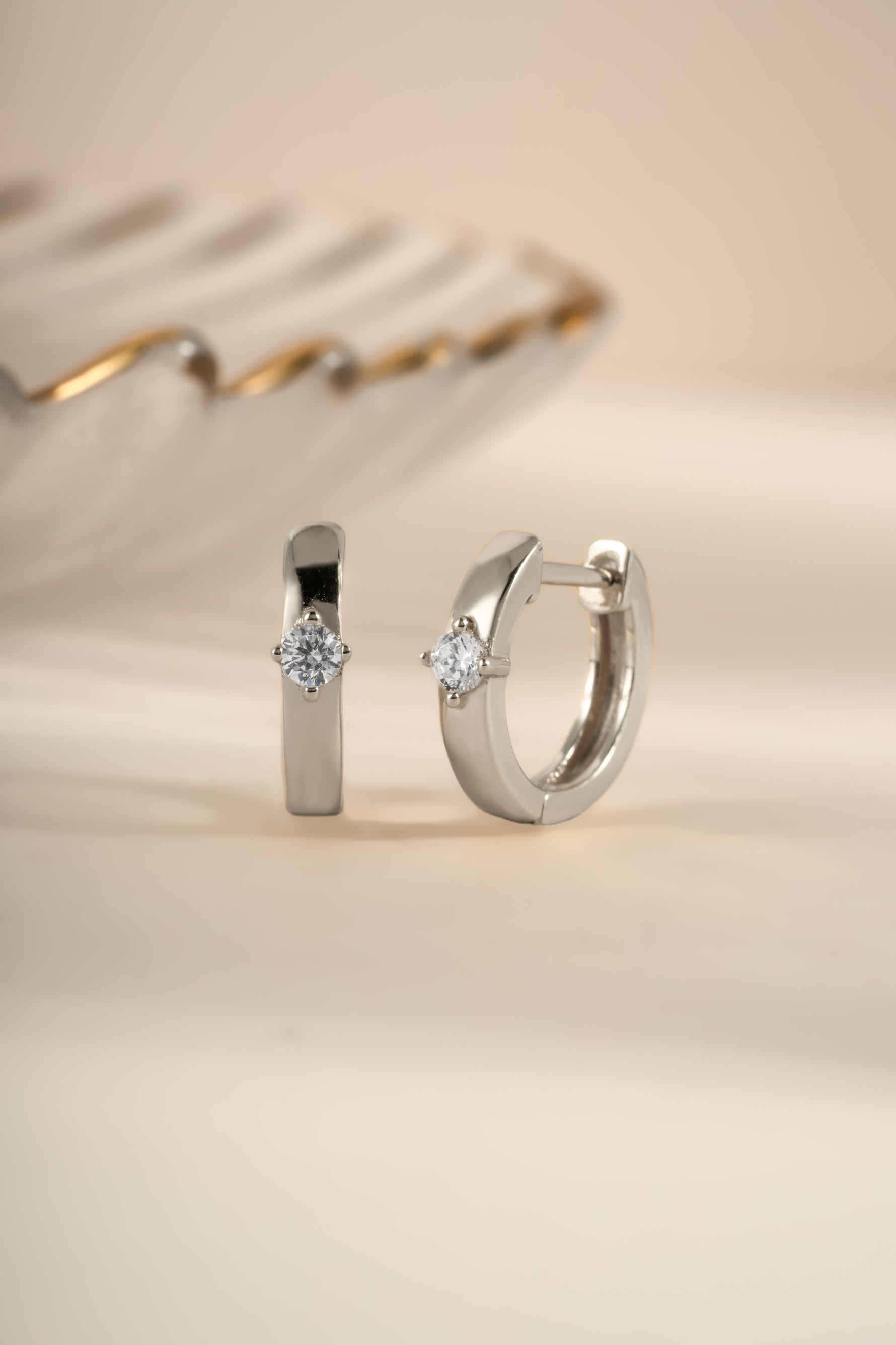 Sami Jewels Bella Huggie Hoop Earrings featuring sparkling diamond accents in sterling silver.