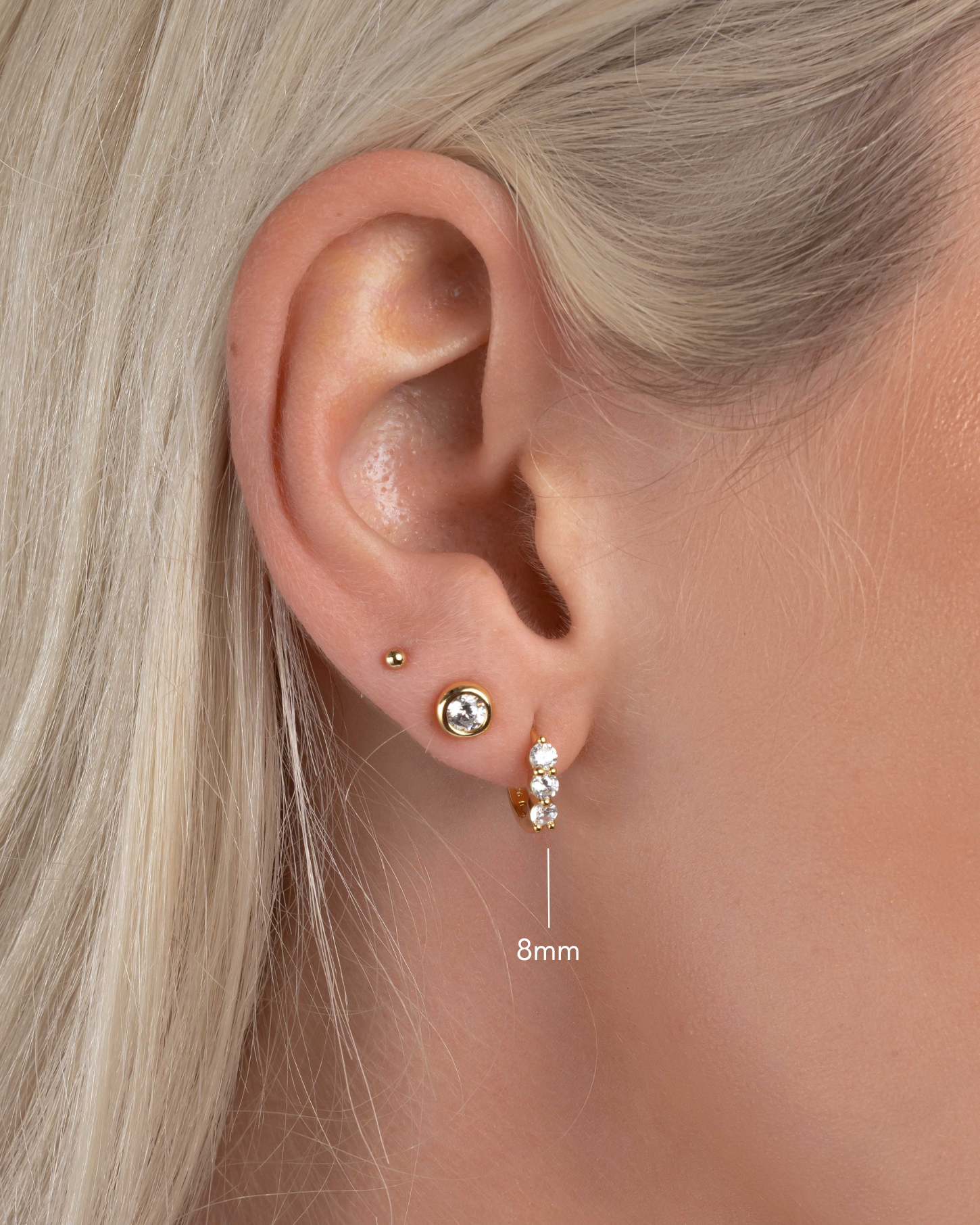 three stone diamond huggie hoop, 8mm in gold on model