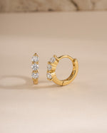 Gold 8mm Stacy Hoop Earrings by Sami Jewels featuring diamond accents, shown from a side view highlighting the huggie design.