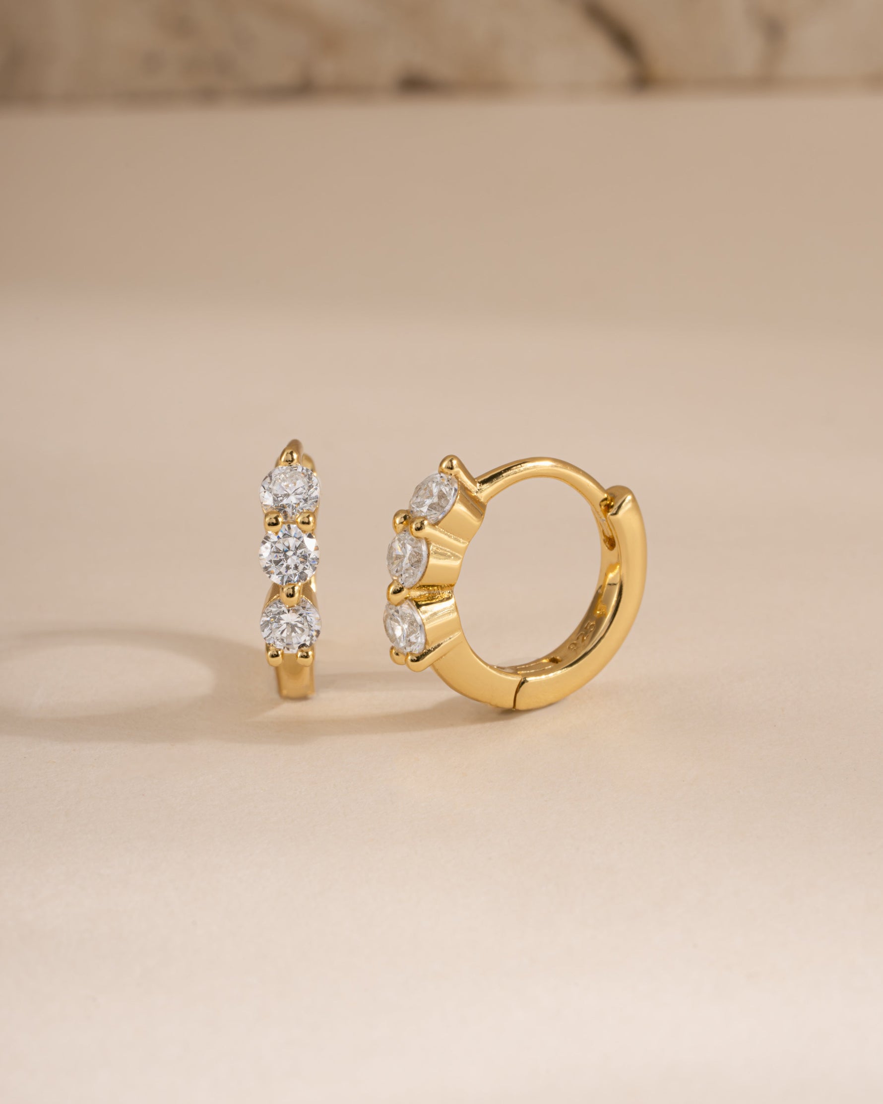 Gold 8mm Stacy Hoop Earrings by Sami Jewels featuring diamond accents, shown from a side view highlighting the huggie design.