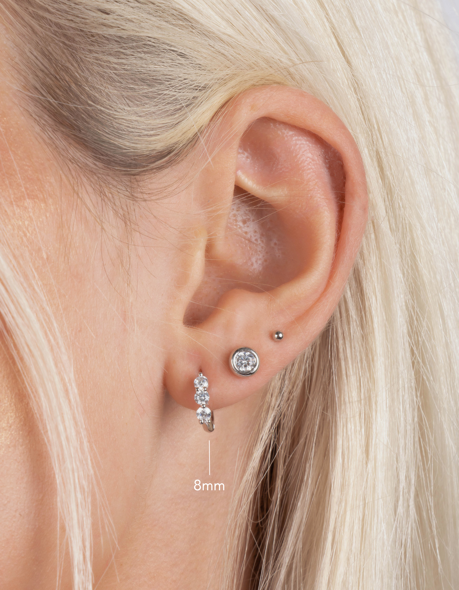 three stone diamond huggie hoop earring stack, 8mm in sterling silver on model