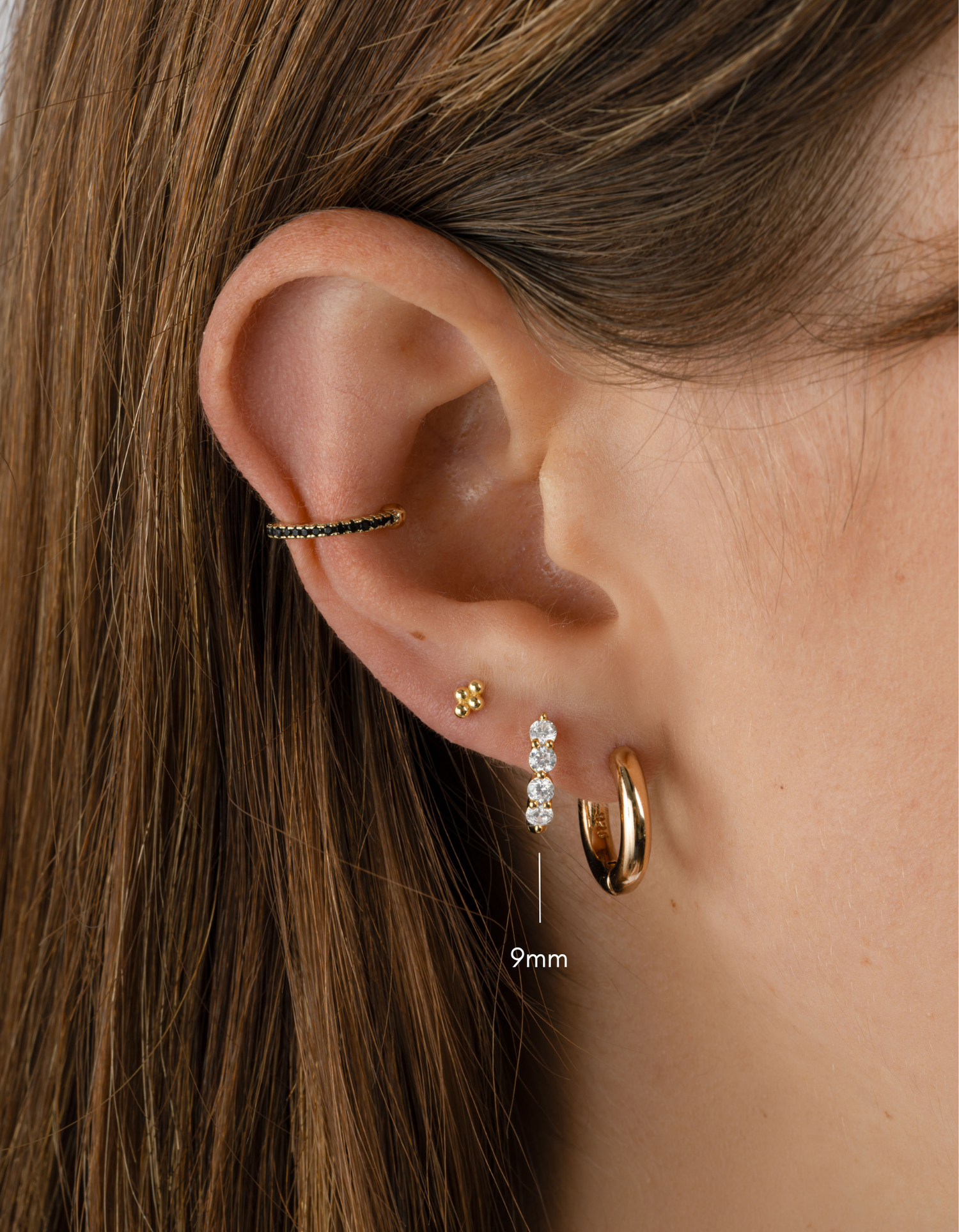 9mm gold Stacy hoop earrings by Sami Jewels featuring diamond accents on small huggie-style hoops.