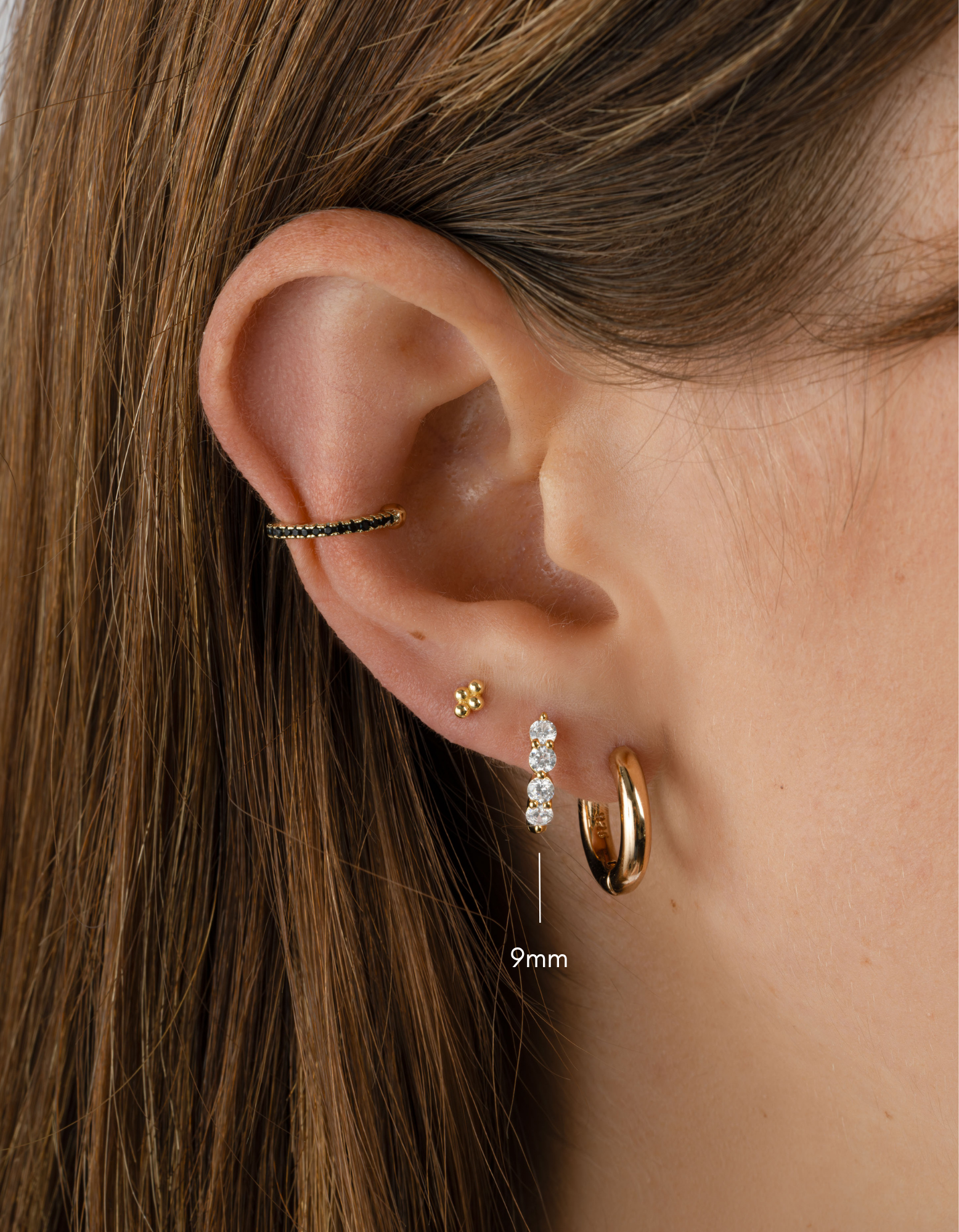 9mm gold Stacy hoop earrings by Sami Jewels featuring diamond accents on small huggie-style hoops.