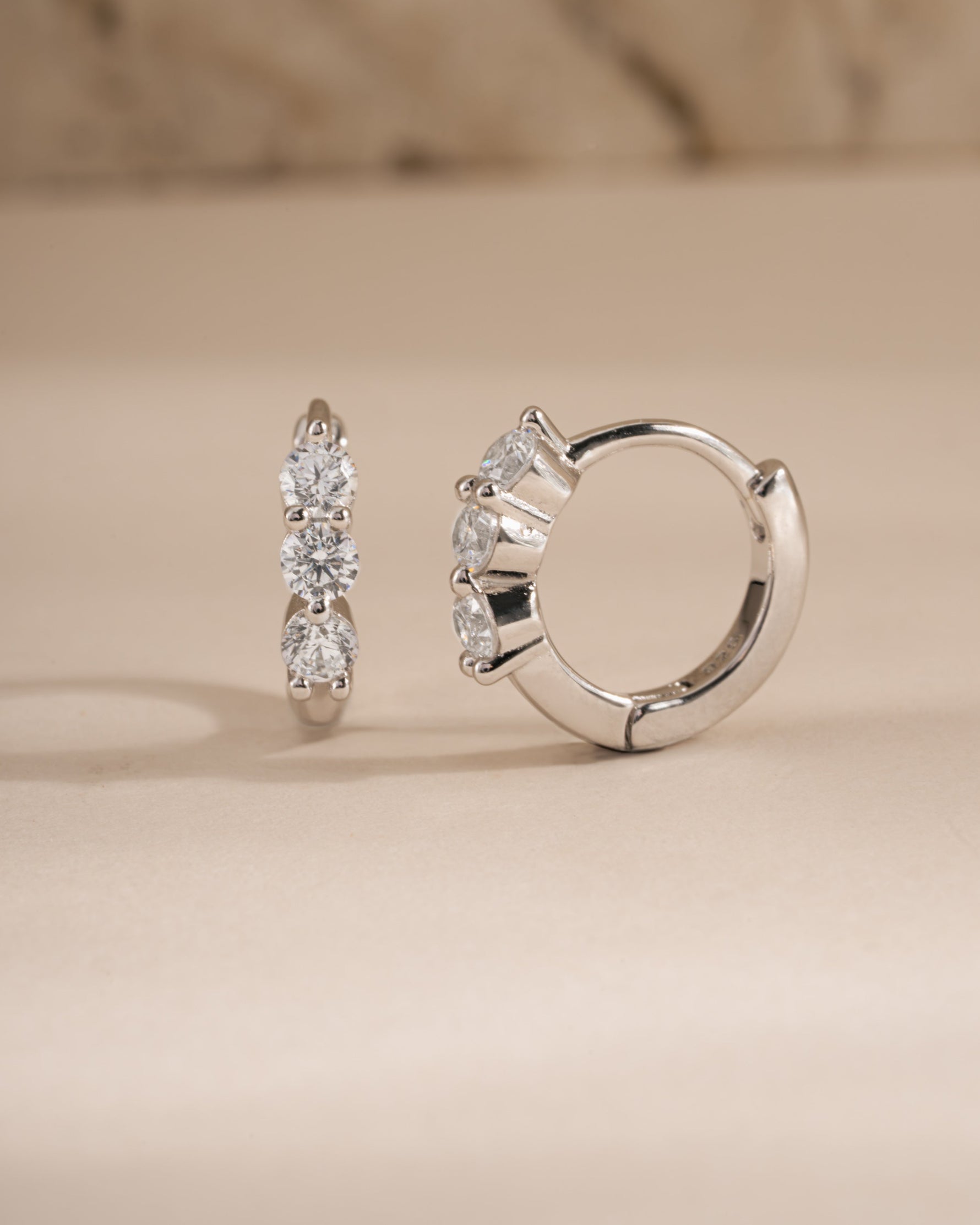 Sterling silver 8mm Stacy hoop earrings by Sami Jewels featuring diamond-huggy design and classic hoop style.