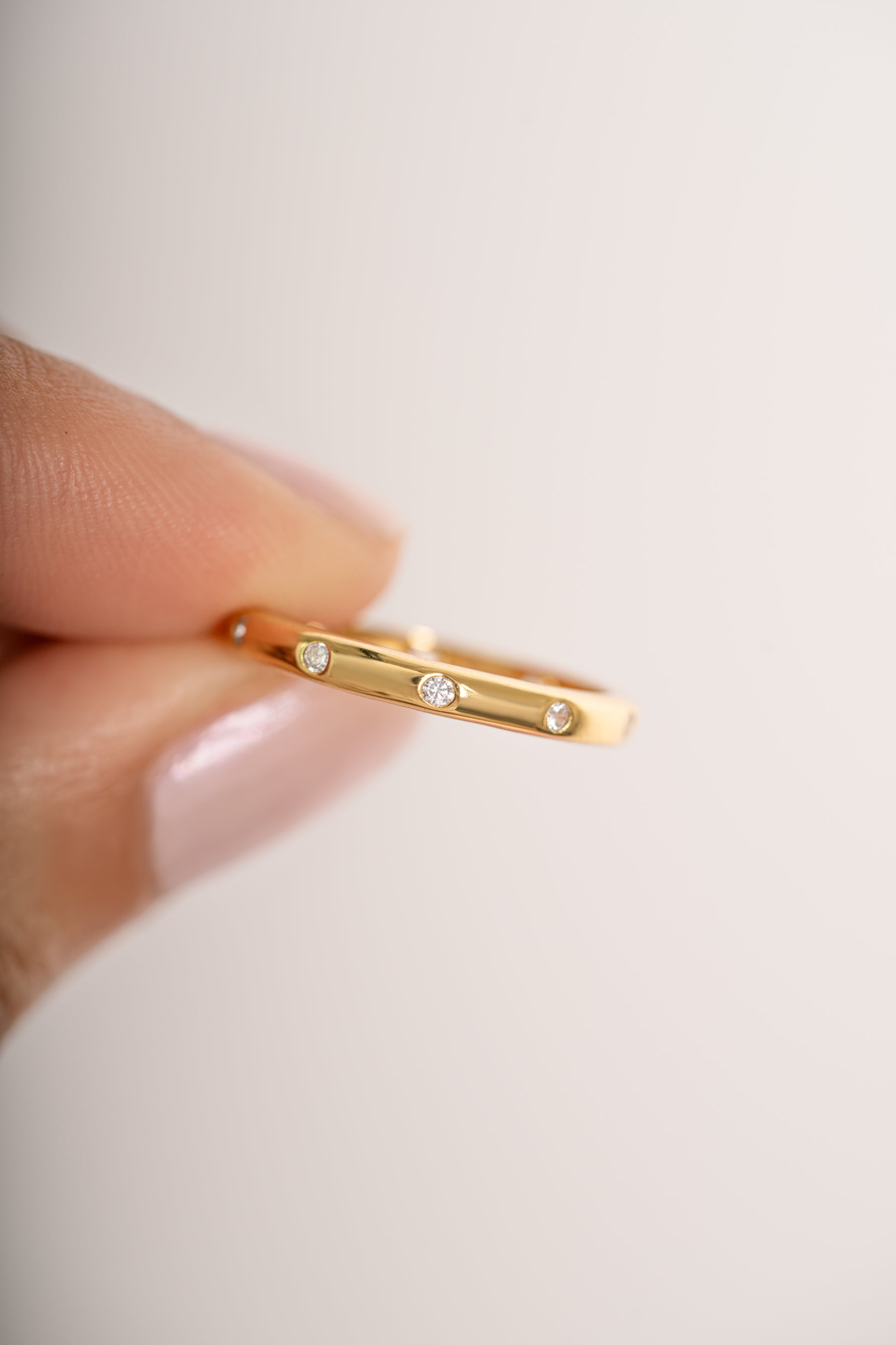 Close-up of Sami Jewels diamond multi-stone gold ring showcasing sparkling multi-faceted gemstones and intricate band design.
