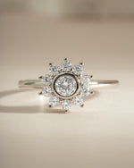 Sterling silver flower ring with diamond accents from Sami Jewels, showcasing intricate floral design and sparkling gemstones.