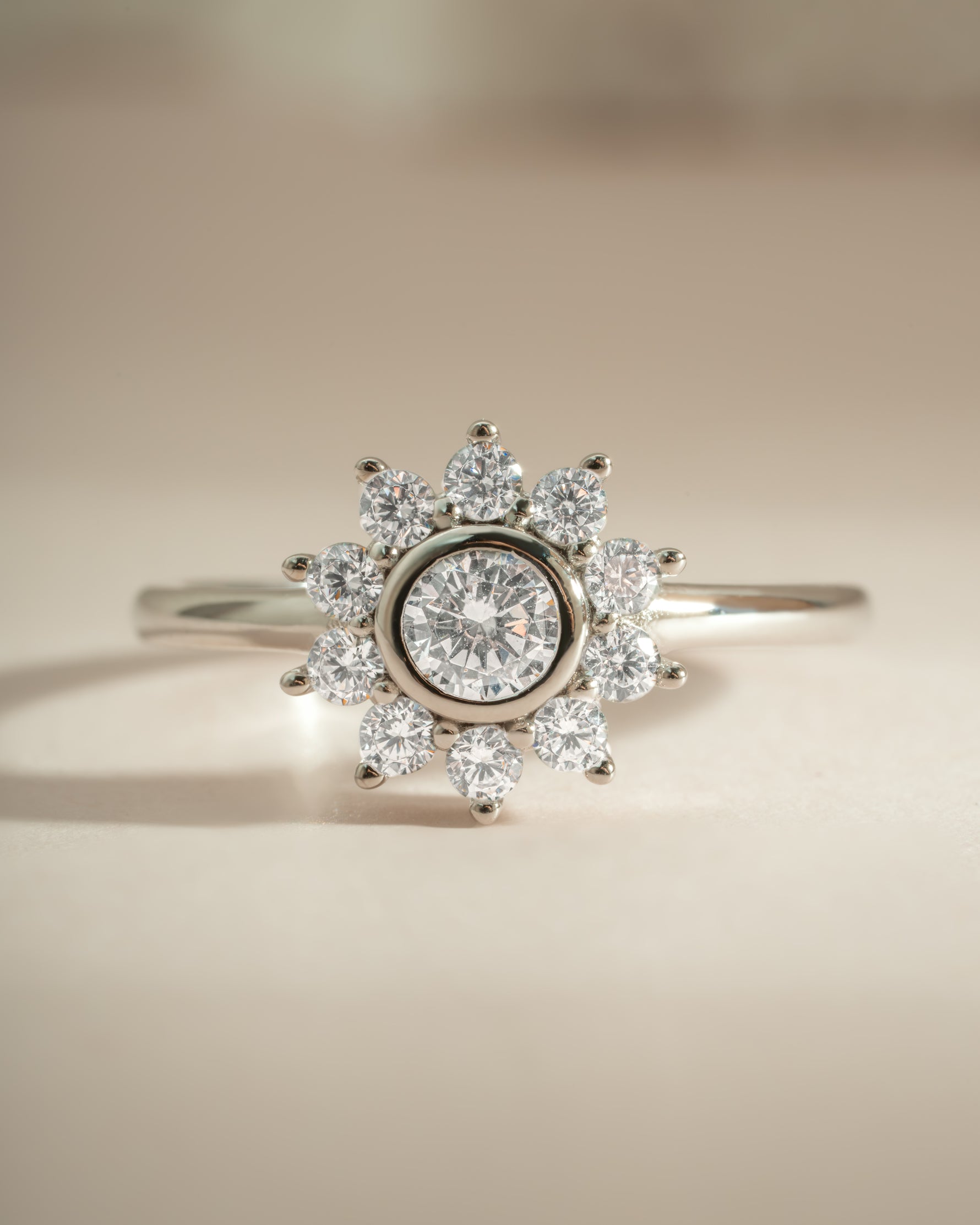Sterling silver flower ring with diamond accents from Sami Jewels, showcasing intricate floral design and sparkling gemstones.