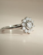 Sterling silver flower-shaped ring with diamond accents from Sami Jewels, showing a side view of the elegant jewelry piece.