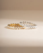 Slanted white cubic zirconia baguette ring by Sami Jewels, featuring gold and sterling silver band with a modern design.