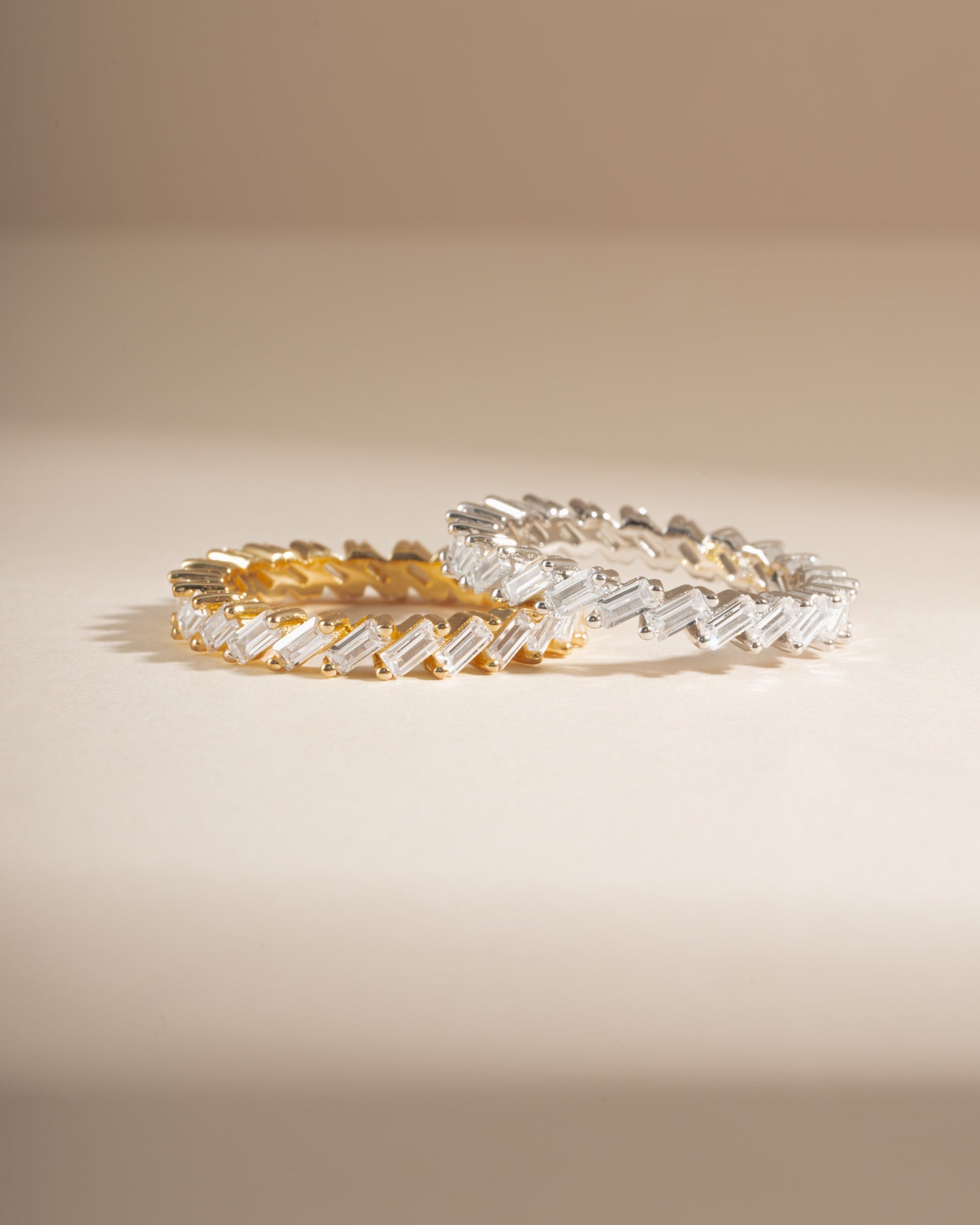 Slanted white cubic zirconia baguette ring by Sami Jewels, featuring gold and sterling silver band with a modern design.
