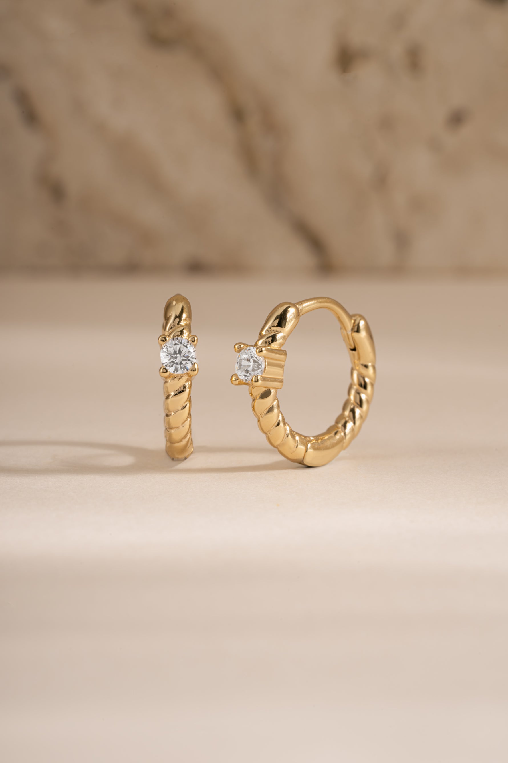 Gold Diamond Spiral Huggie Hoop Earrings by Sami Jewels featuring sparkling diamonds and a stylish spiral design.