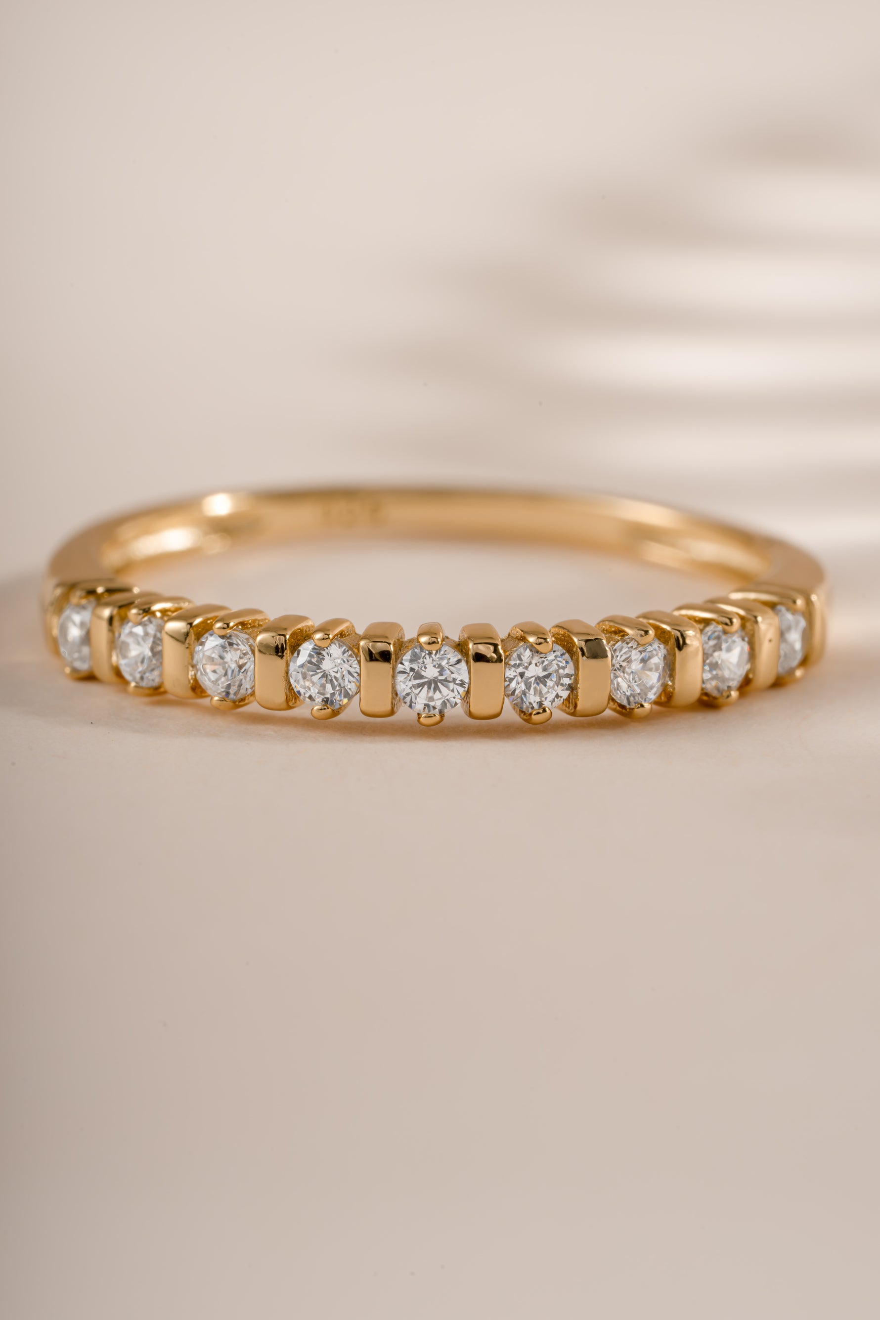 Close-up of Sami Jewels Bianca stacking ring featuring a gold band with diamond accents, showcasing elegant layered jewelry design.