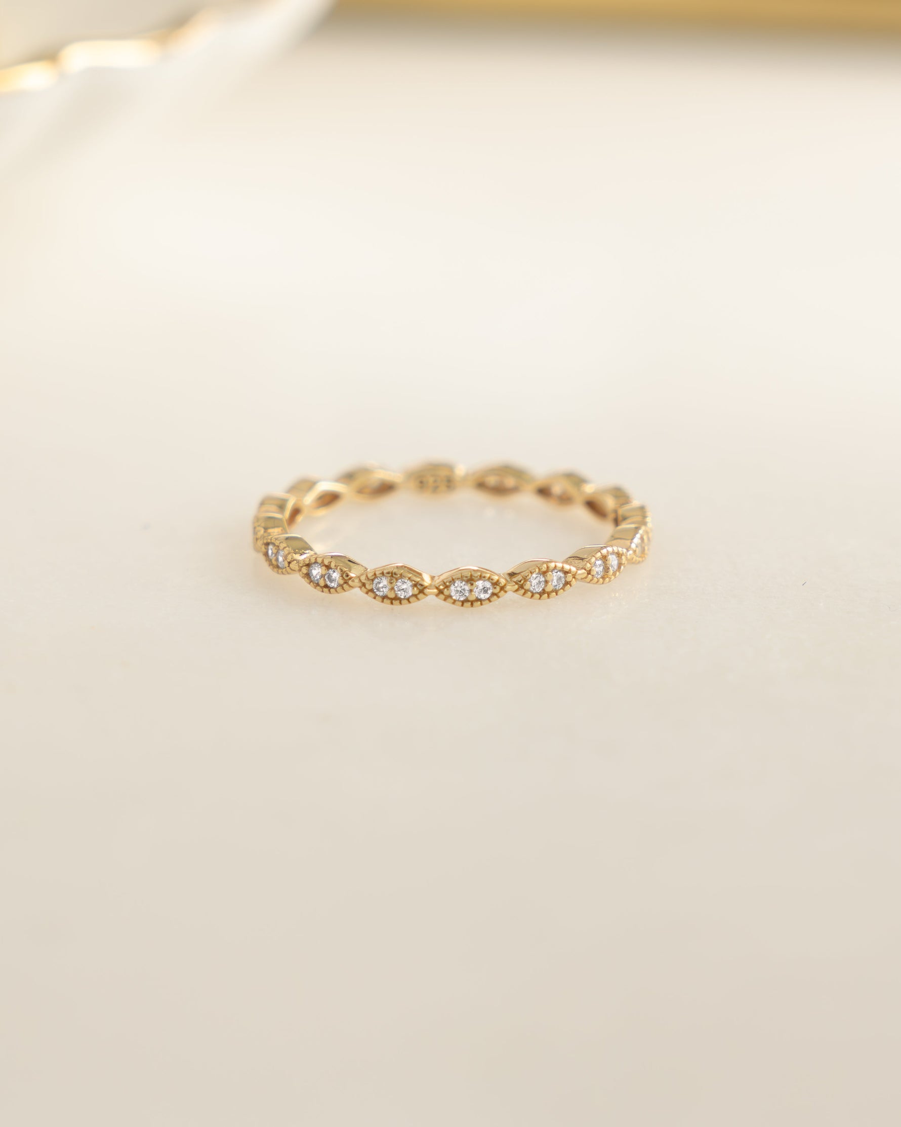 Gold diamond stacking ring by Sami Jewels featuring a row of sparkling diamonds, front view showcasing elegant design.