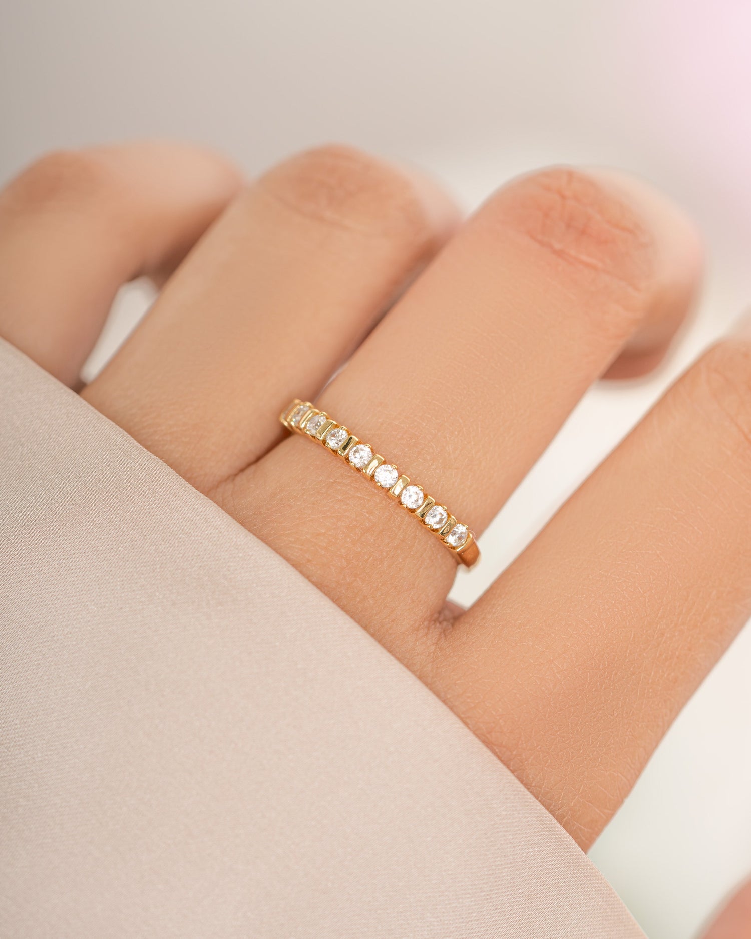 Gold Bianca stacking ring with diamond accents by Sami Jewels, featuring a sleek, modern design on a model's finger.