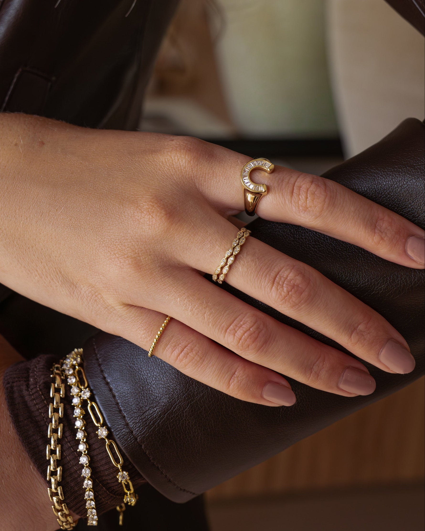 Gold diamond stacking ring by Sami Jewels worn on model's finger, showcasing elegant jewelry design and sparkling gemstones.
